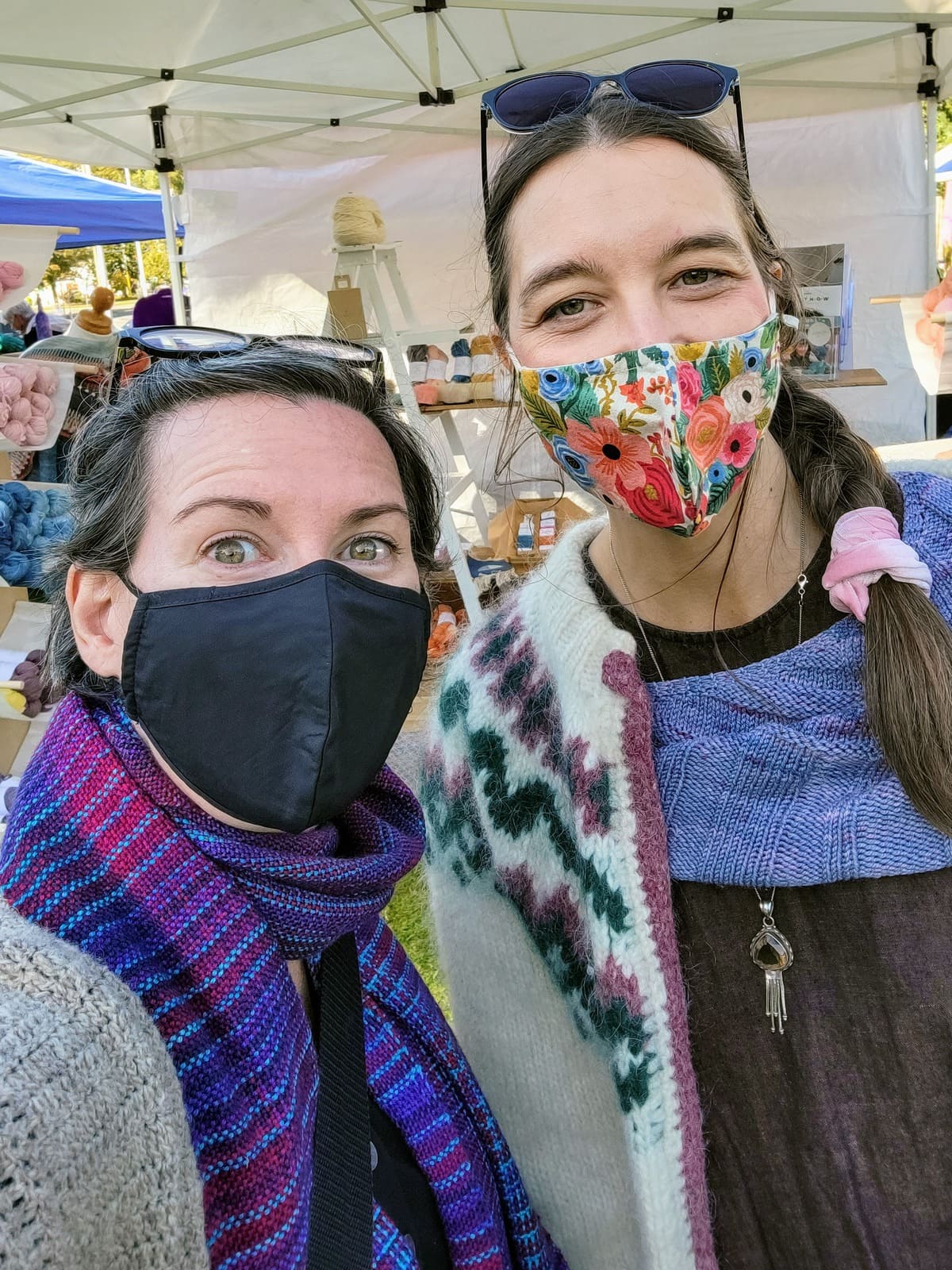 Image description: Two white women wearing face masks pose for a selfie.