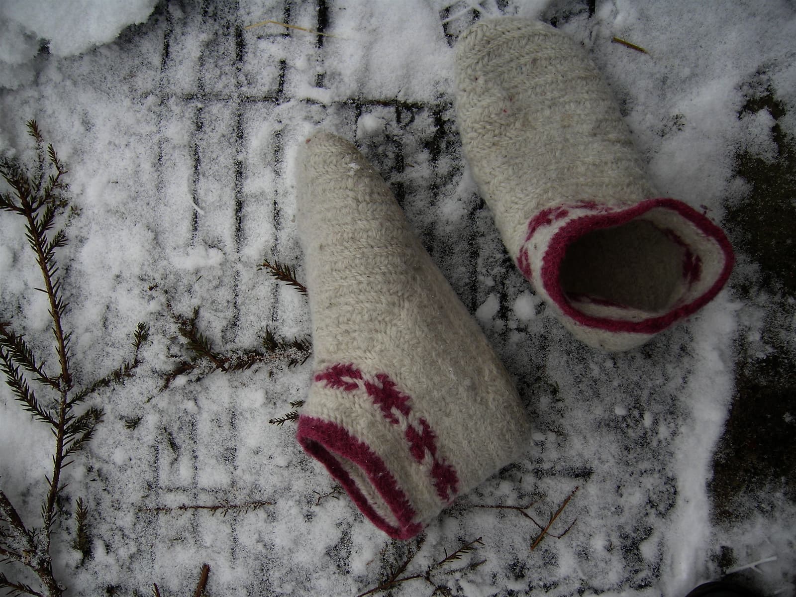 image description: a pair of short heavy woollen socks created with the nalbinding technique
