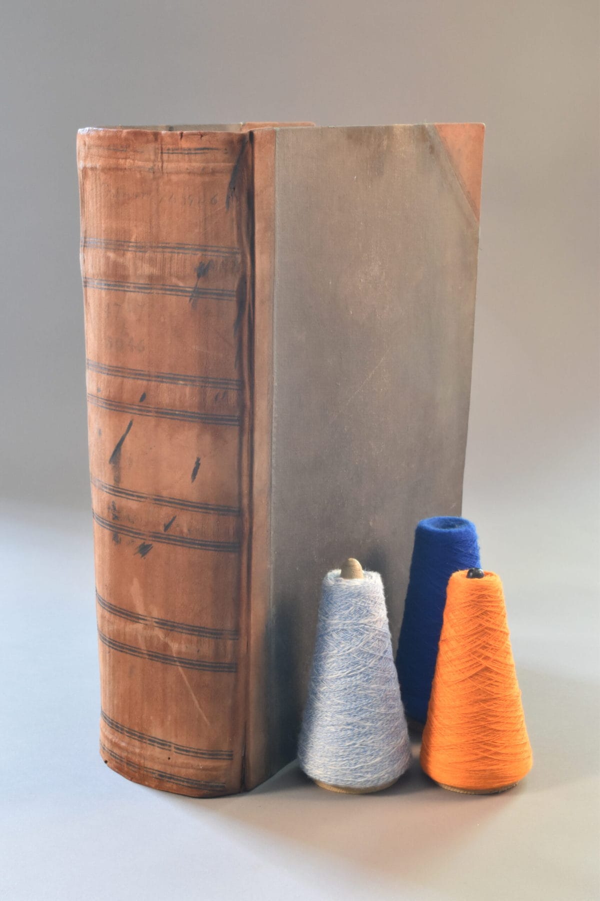 image description: an old book, the image focussing on its spine