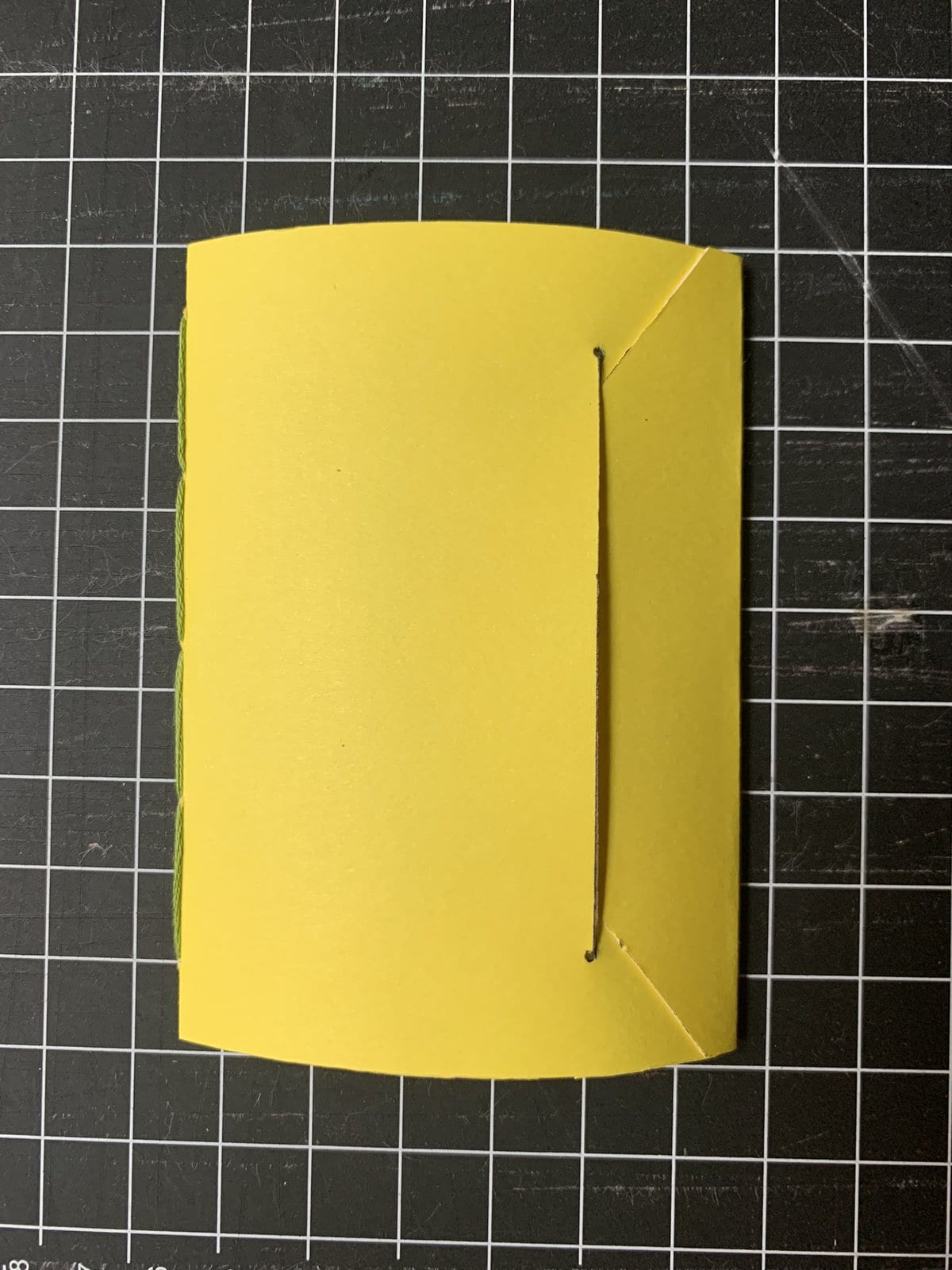 image description: a small cardstock folder, covers folded closed