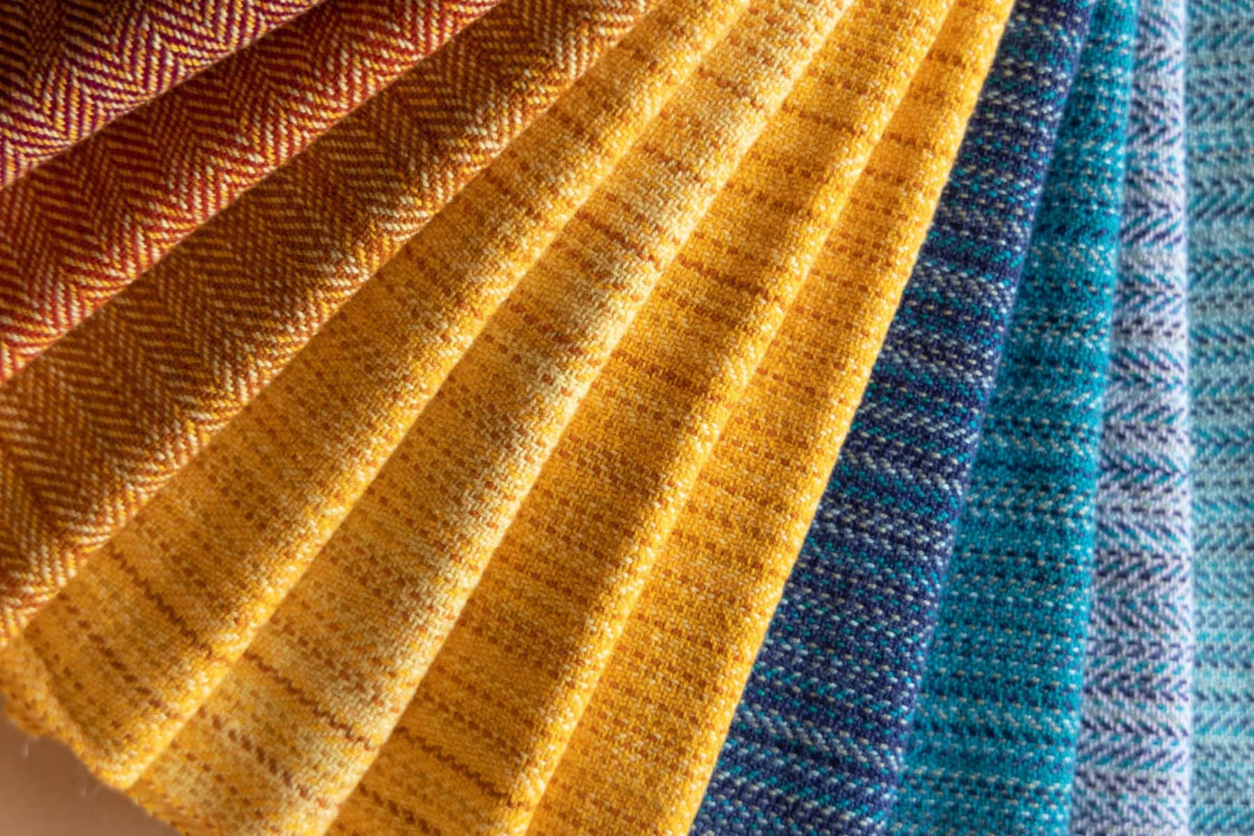 image description: handwoven fabrics in a variety of colours